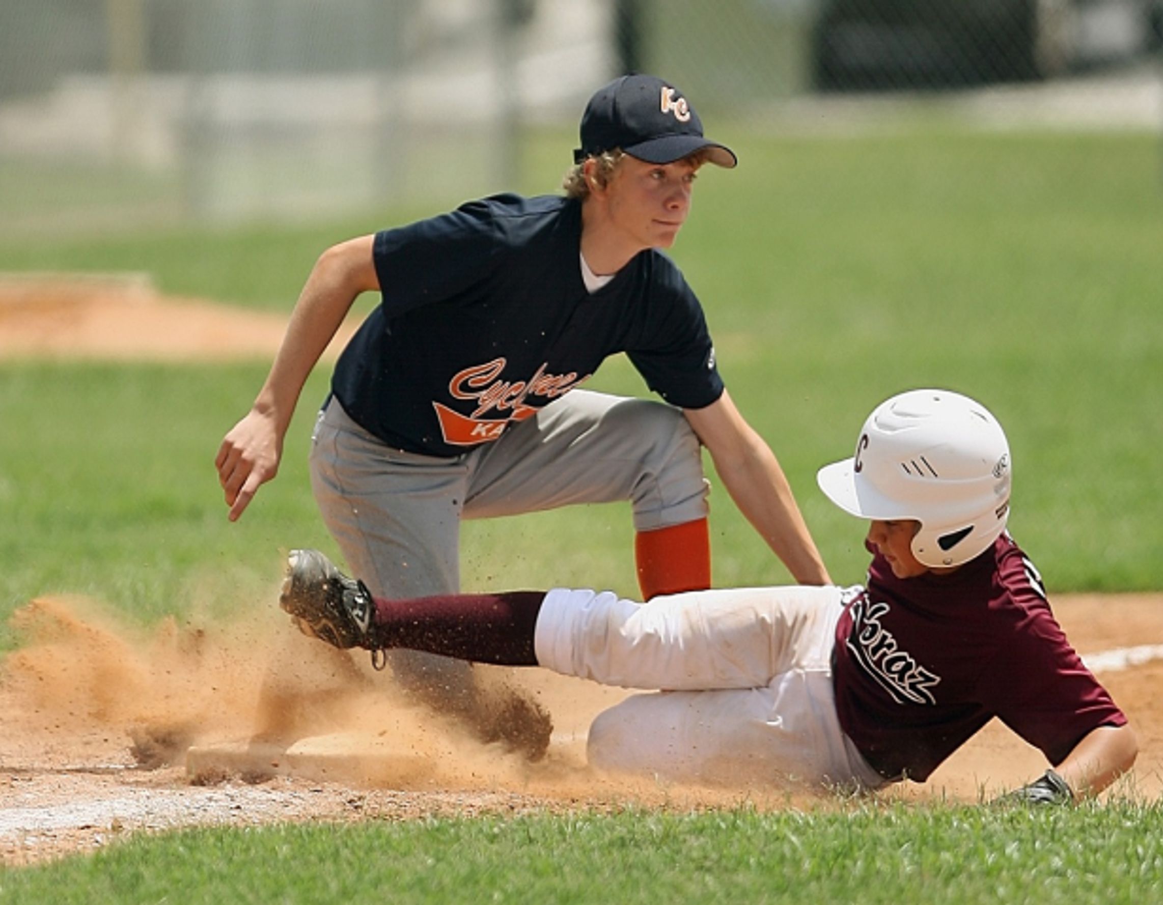 Player kicking up
sand sliding into base
